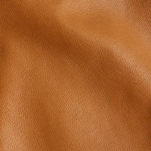 Extreme close-up of tan calf leather grain with a soft sheen.
